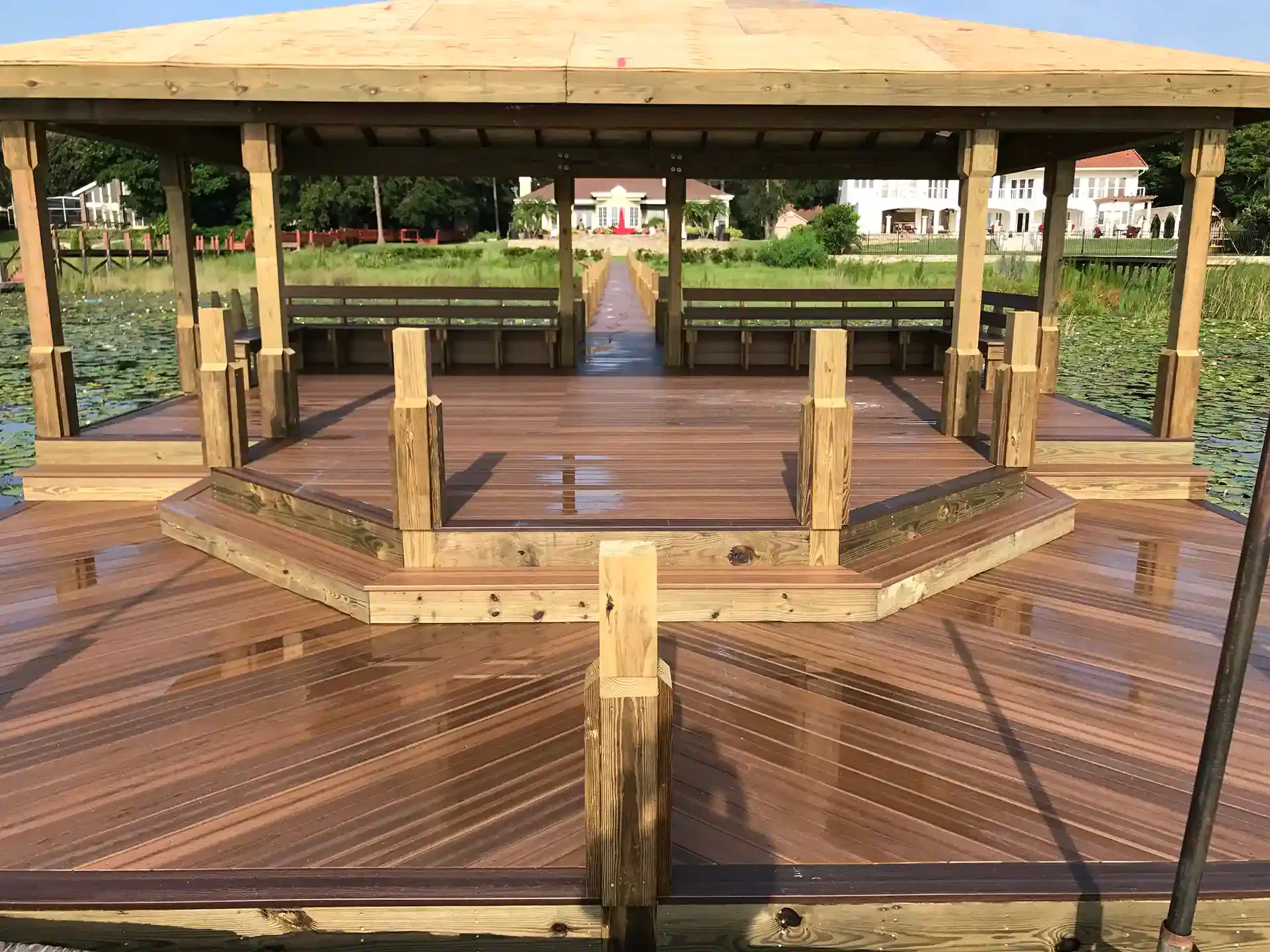 covered dock with composite decking, built-in benches, and a scenic waterfront view.