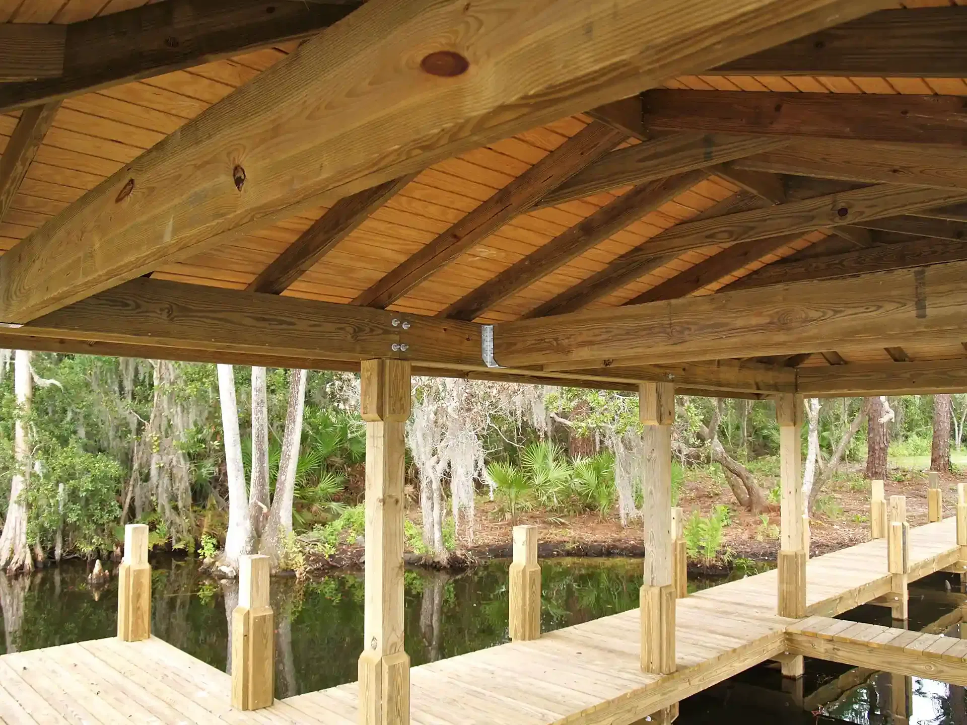 Photo of a wooden boat dock with a dock cover