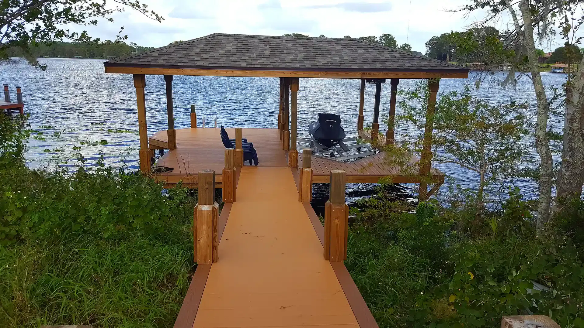 Photo of composite decking used for a walkway, dock, and boat house