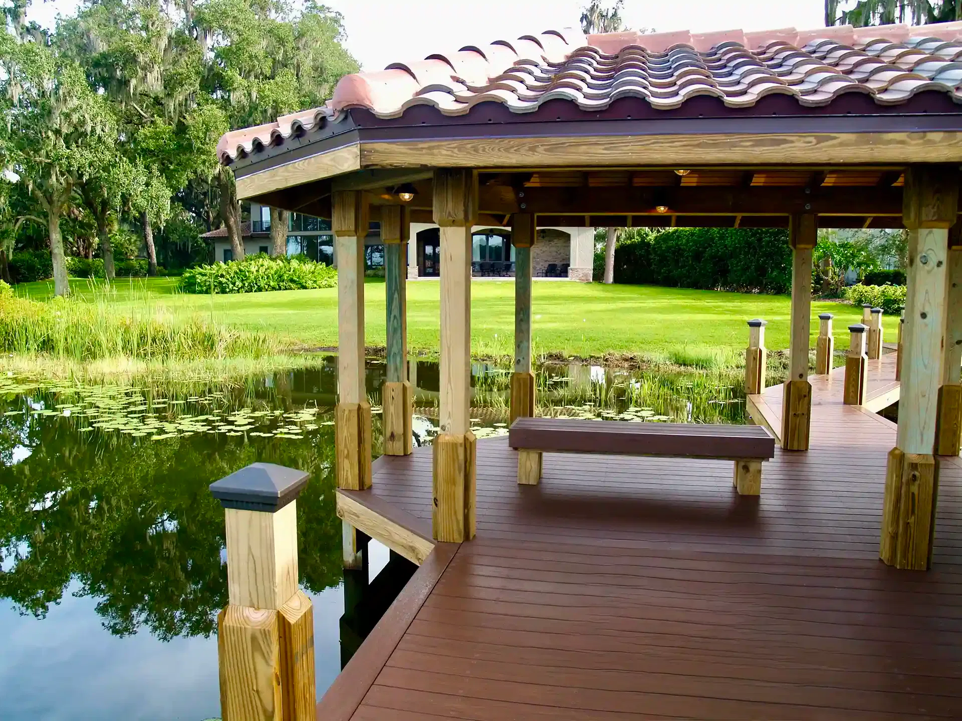 Photo of a custom dock with roof and built-in bench. 