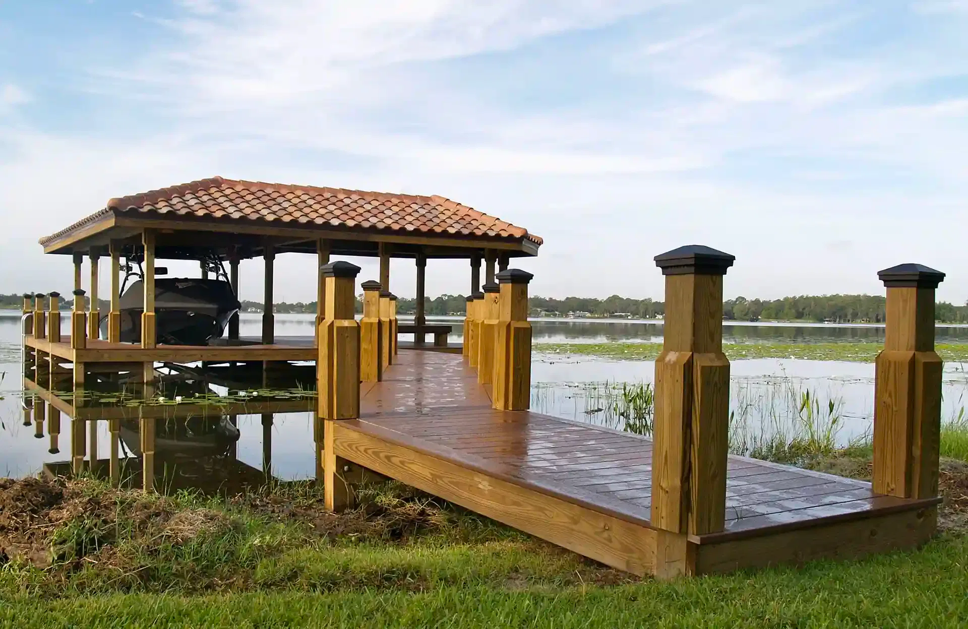 Photo of a custom dock with walkway, zen bench, and boat lift. 