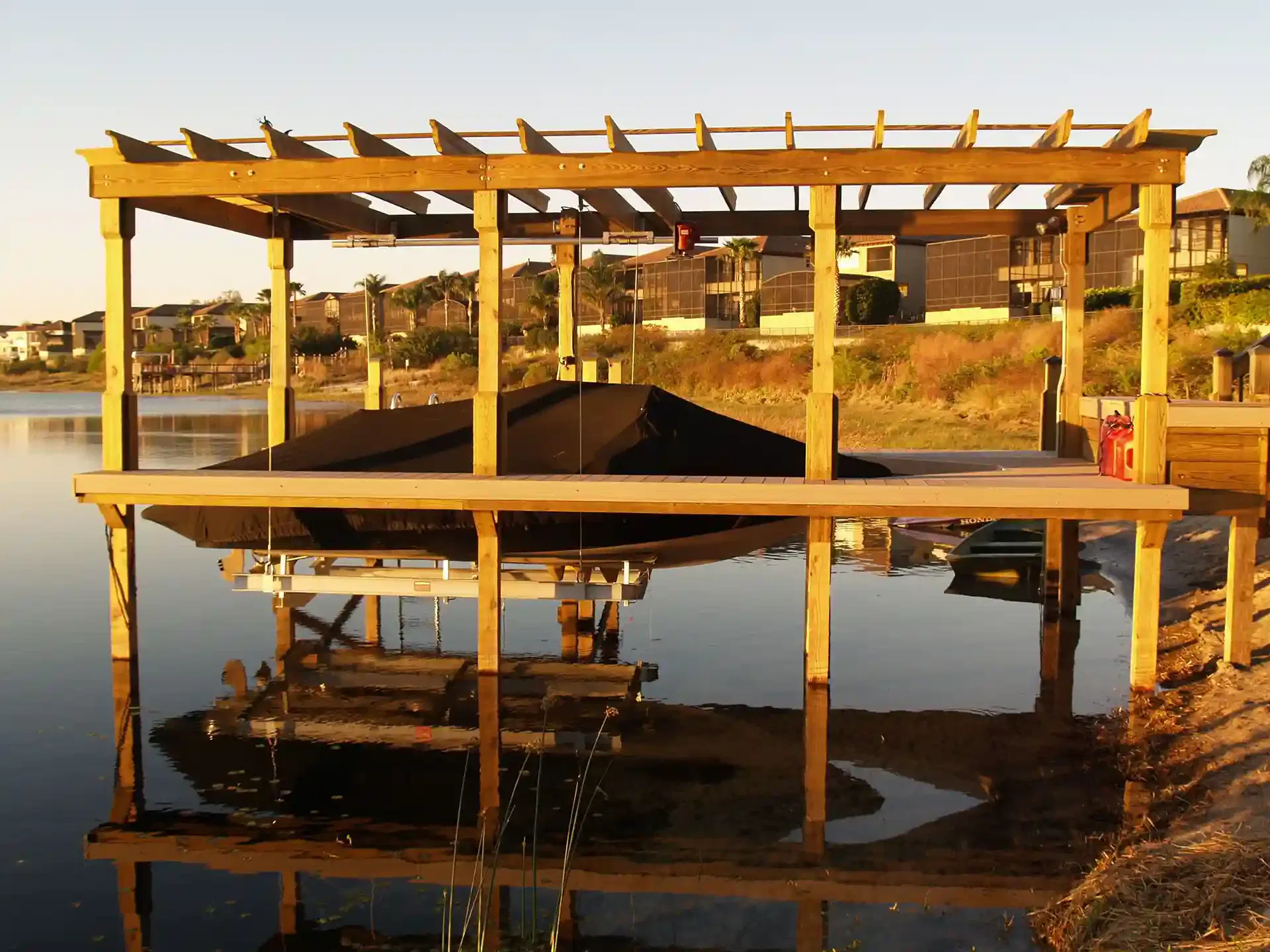 Photo of a boat lift with a pergola cover.