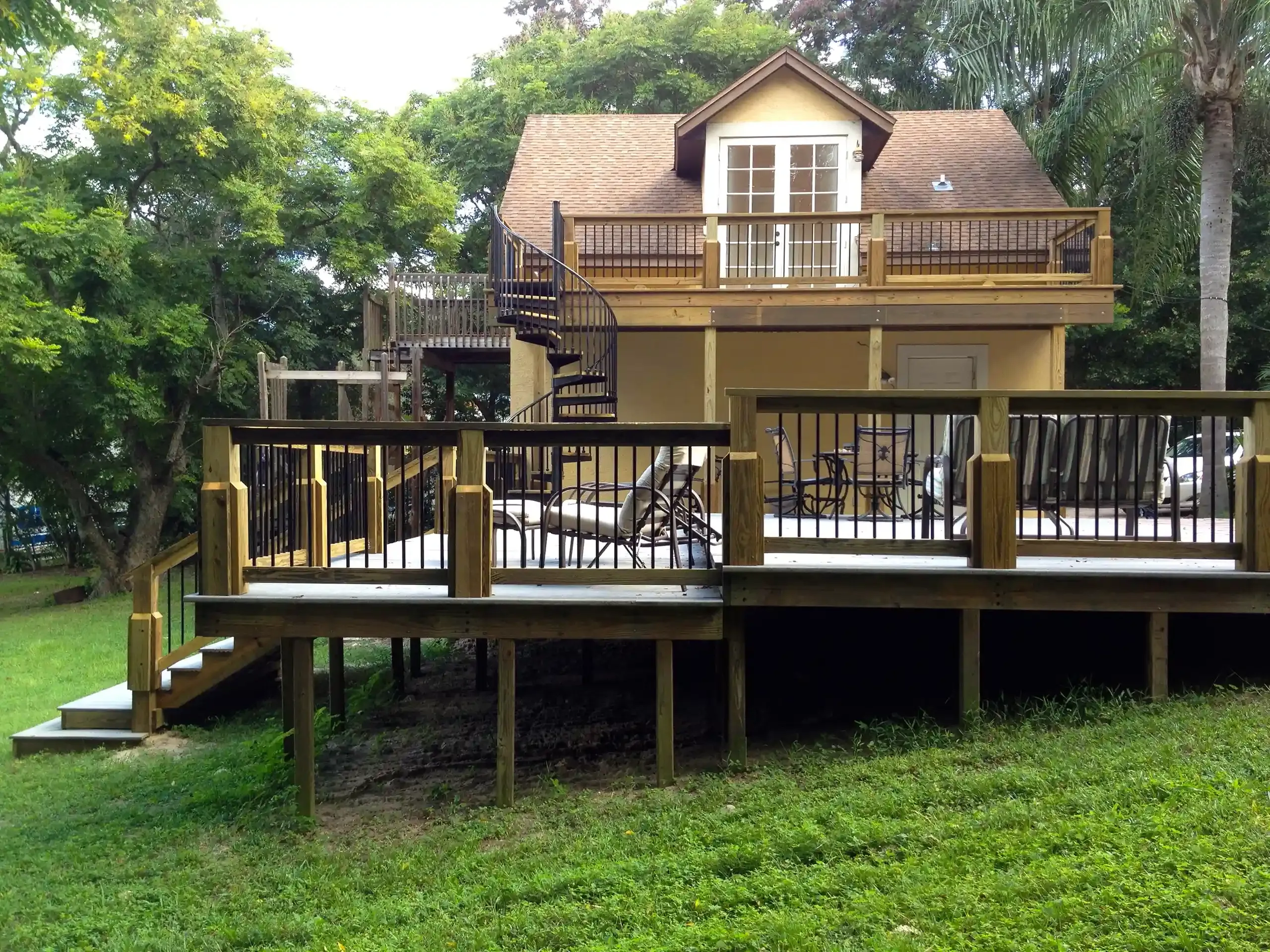Your Go-To Deck and Dock Builder in Central Florida 1 photo of a multi-level deck with a balcony deck and spiral staircase