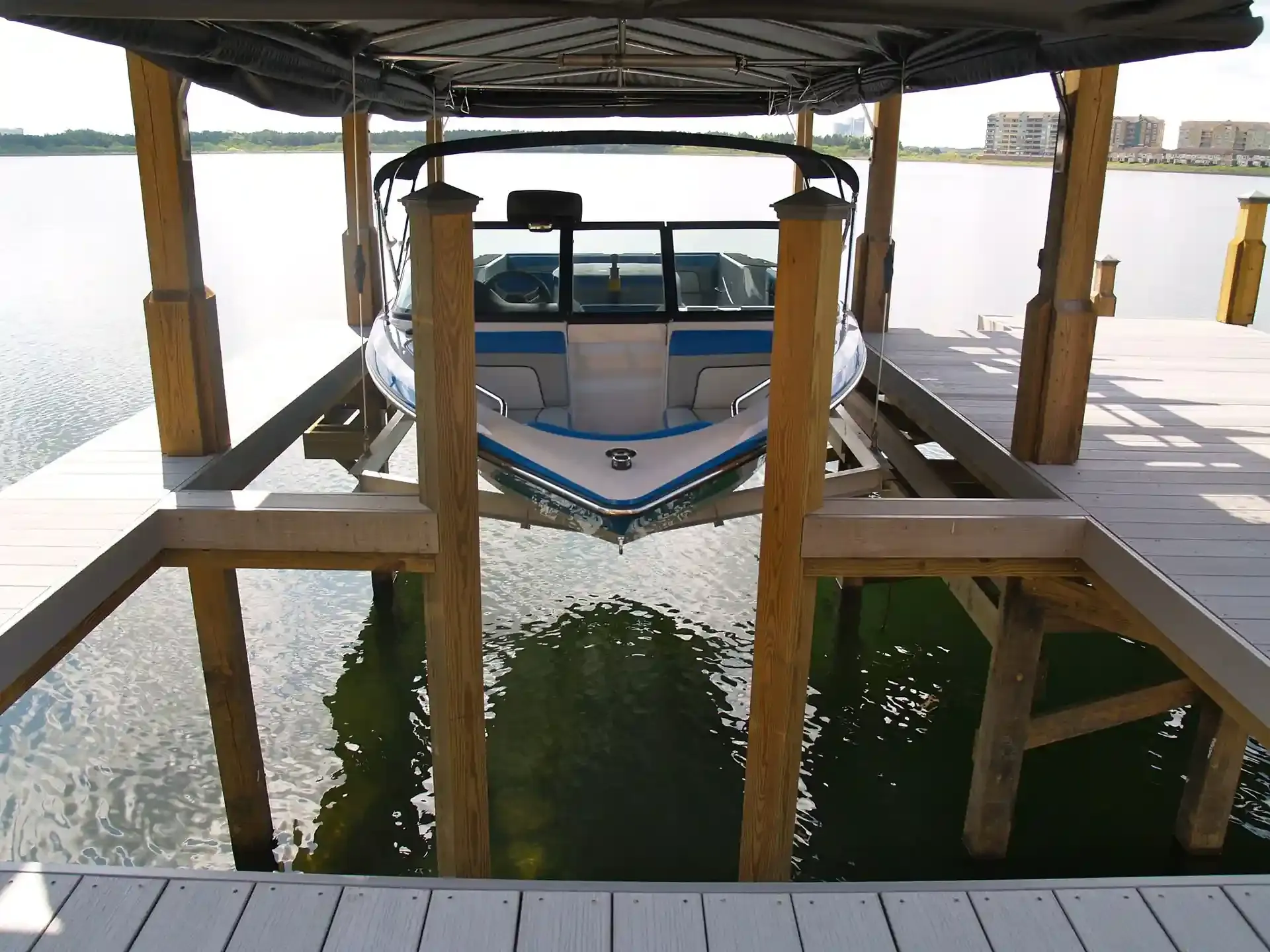 photo of a boat on a boat lift in a covered boat dock