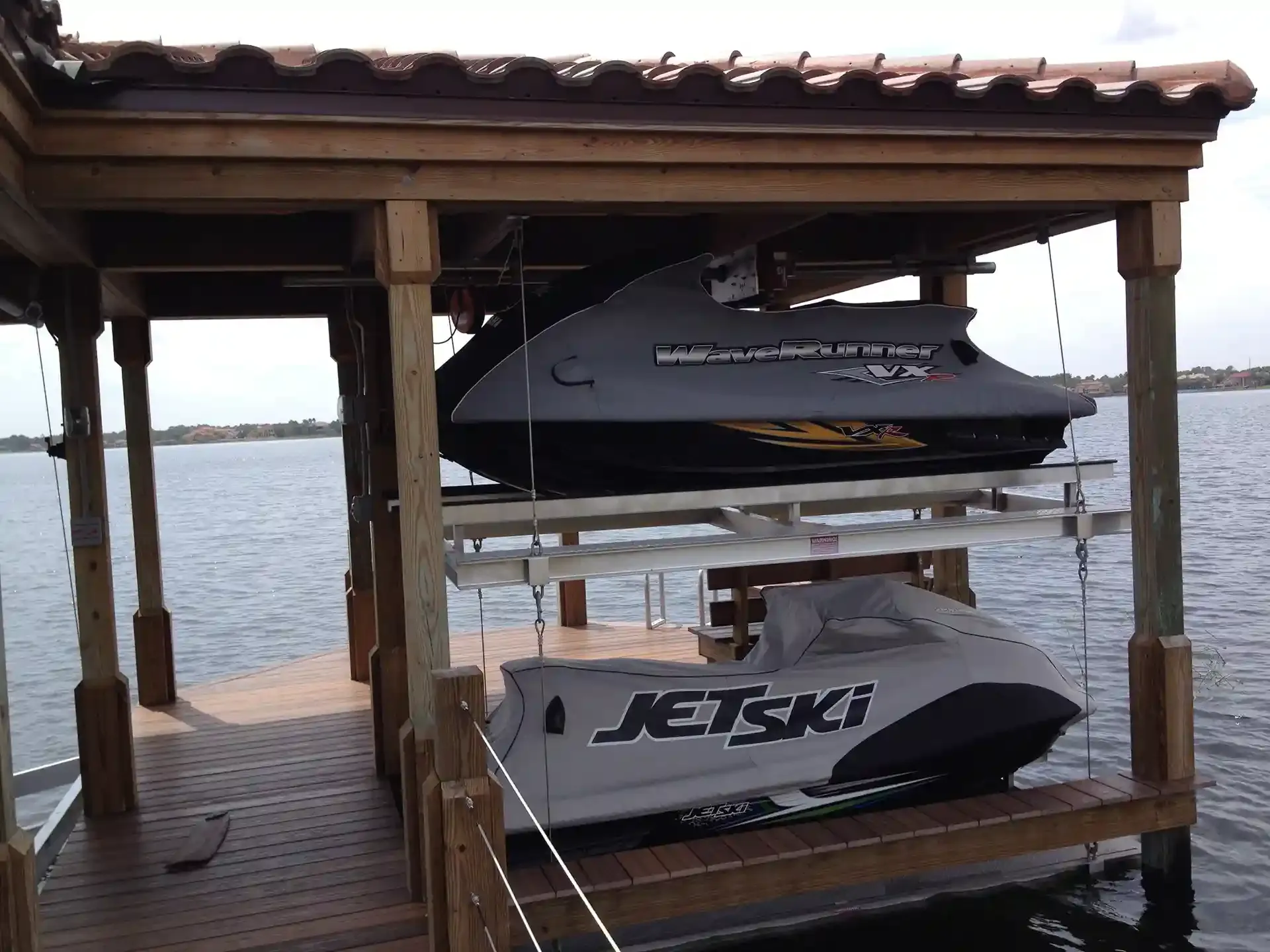 Photo of a boat house with a double jet ski lift