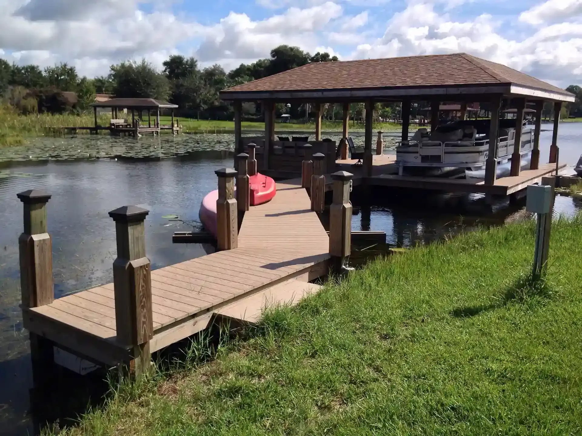 Photo of a pontoon boat on a boat lift in a boat house