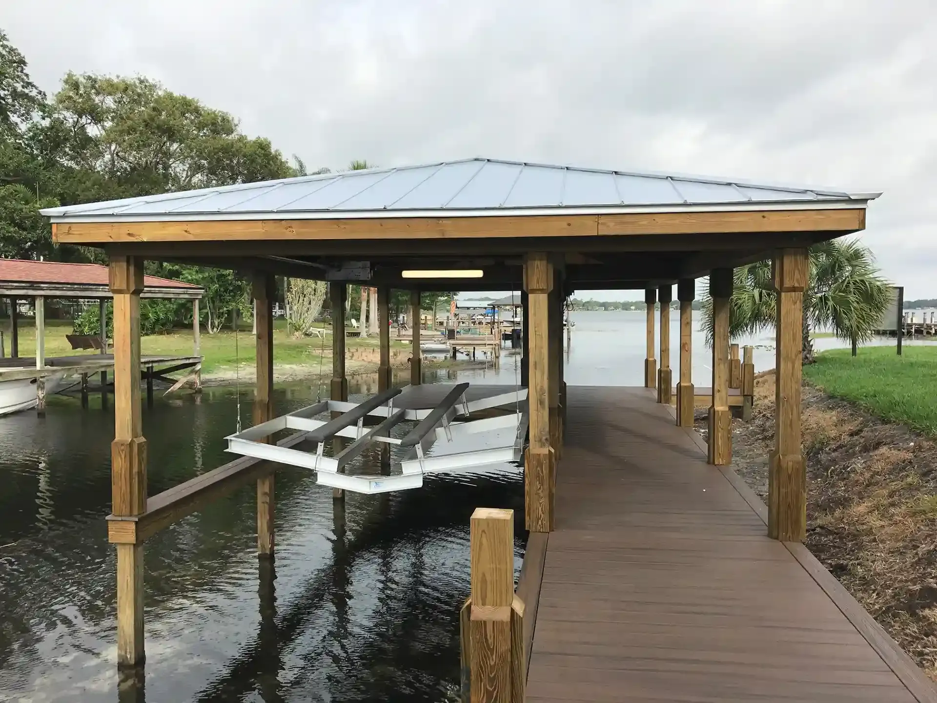 Photo of a boat house on a canal with a boat lift installation