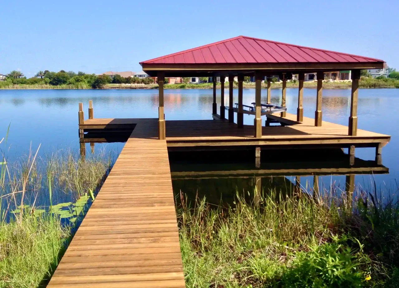 Photo of a boat house with roof and boat lift.